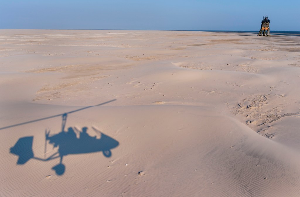 shadow of Gyrocopter on the sand