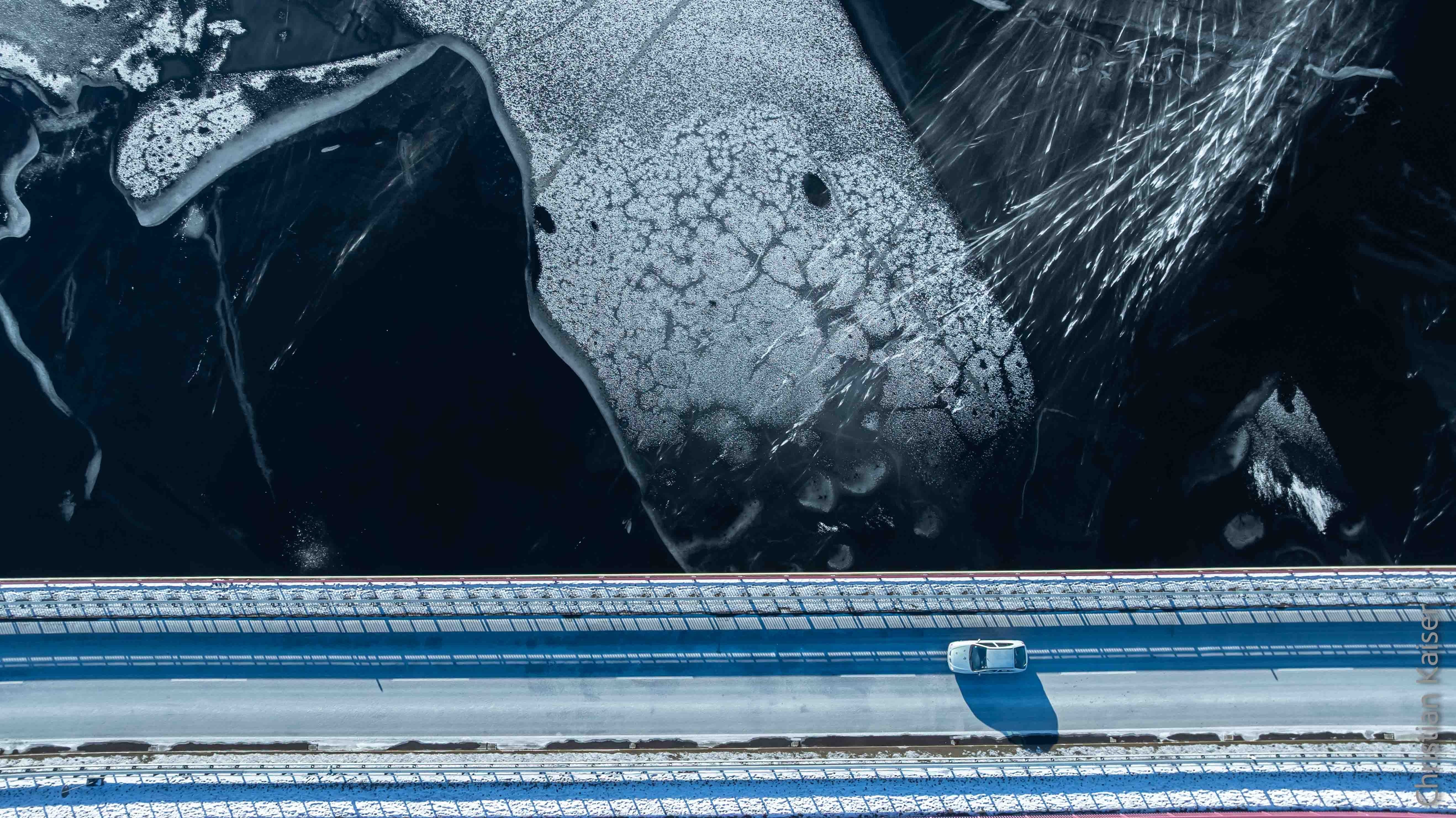 water, ice and a car on the bridge
